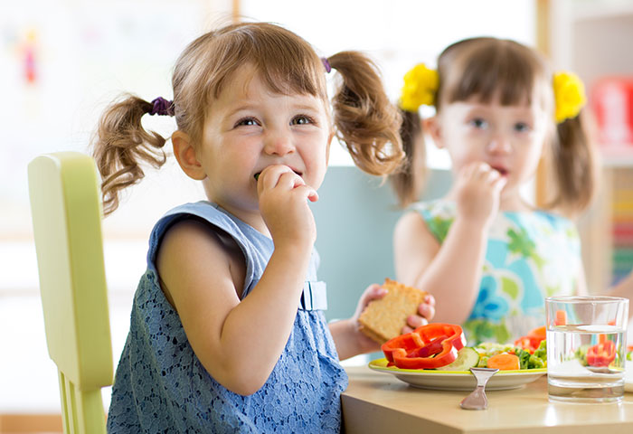 Girls eating snacks at day care